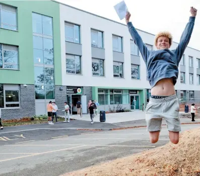  ?? ?? Jude Alexander jumps for joy at Burnham Grammar School. Ref:134778-6-4