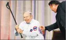  ??  ?? In this Jan 15, 2016 file photo, former Chicago Cubs second baseman Glenn Beckert swings his cane as he gets a fist bump from radio personalit­y Ron Coomer during the baseball team’s convention in Chicago. (AP)