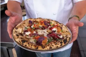  ?? Getty Images for NYCWFF ?? New York pizza is canceled, according to some on the right. Photograph: Kris Connor/