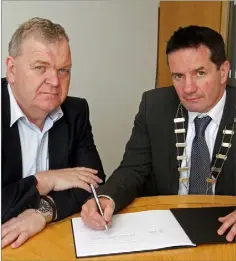  ??  ?? County Council Chairman, John Hegarty (right), and Pat Collins, County Secretary, open the book of condolence to remember victims of the Las Vegas tragedy at County Buildings.