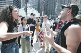  ?? Jim Young AFP/Getty Images ?? A PRO-MUSLIM activist, left, argues with a demonstrat­or in Chicago. Act for America organized nearly two dozen rallies in parks and plazas across the country.