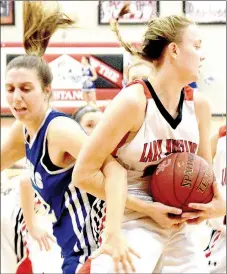  ?? PHOTO BY RICK PECK ?? McDonald County’s Tricia Wattman gets tangled with a St. Mary’s Colgan player while getting a rebound during the Lady Mustangs’ 39-37 loss on Dec. 13 at MCHS.