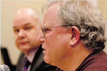  ?? GREG SOUTHAM/EDMONTON JOURNAL ?? Minister of Health Fred Horne watches Dr. James Talbot, Chief Medical Officer of Health, speak Wednesday about Alberta’s vaccinatio­n program.