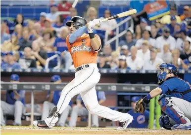  ?? LYNNE SLADKY/AP ?? Miami’s Martin Prado rips his two-run double into the left center field gap in the first inning that gave the Marlins a 3-0 lead they would never lose.