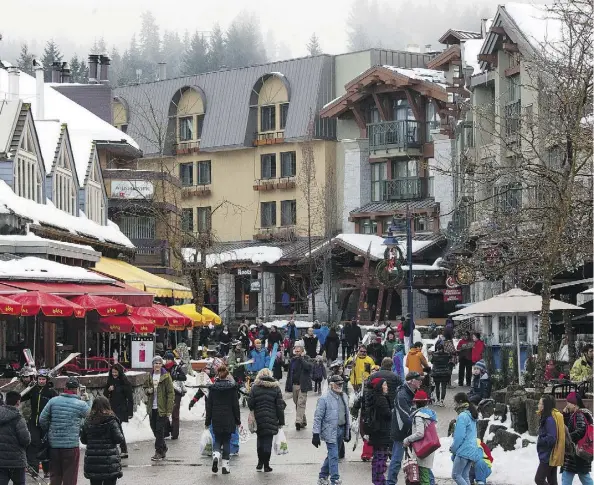  ?? DAVID RYDER/BLOOMBERG ?? Tourists walk through Whistler Village in Whistler, B.C., which has become Canada’s most expensive place to live, its housing market and rental markets outpacing even out-of-control cities such as Toronto and Vancouver, which is making it hard for...