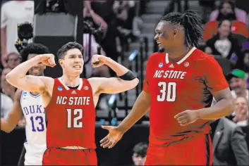  ?? Tony Gutierrez The Associated Press ?? The physical, inside presence of N.C. State’s DJ Burns (30) gives handicappe­rs reason to believe the Wolfpack will cover against Zach Edey and Purdue.