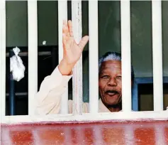 ??  ?? Freed: Mandela looks out of his old cell on a 1994 visit