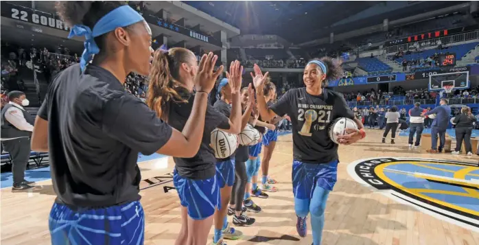  ?? JOSHUA HUSTON/GETTY IMAGES ?? Candace Parker, high-fiving her Sky teammates before their opener, thinks giving every WNBA team three additional roster spots would be healthier for the league than adding two expansion franchises.