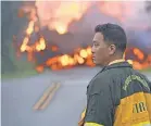  ??  ?? Don Yokohama, a forester for Hawaii, watches lava advance through the Leilani Estates neighborho­od.