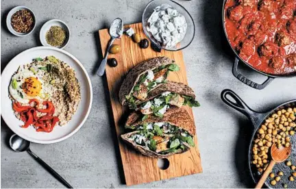  ?? ANDREW SCRIVANI/THE NEW YORK TIMES ?? An all-day Mediterran­ean menu features savory oats with fried egg and za’atar, from left, chicken salad pita and spicy meatballs with chickpeas.