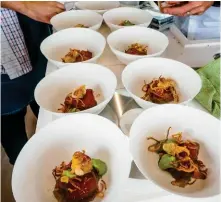  ??  ?? RIGHT Seared yellowfin tuna is readied for service in Nautibuoy’s galley.