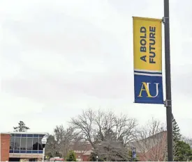  ?? ERIN BORMETT / ARGUS LEADER ?? A sign for Augustana University hangs from a lamp post on April 27, 2021, on Augustana’s campus in Sioux Falls.