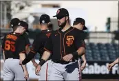  ?? ROSS D. FRANKLIN — THE ASSOCIATED PRESS ?? Giants catcher Joey Bart and teammates stretch during spring training workouts for pitchers and catchers on Wednesday in Scottsdale, Ariz.
