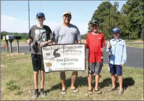  ?? The Sentinel-Record/Richard Rasmussen ?? FISHING DERBY: From left, Carson Armstrong, Jeff Newman, Andrew H. Hulsey State Fish Hatchery manager, Griffin Ralph and Gavin Ralph display a poster promoting Saturday’s annual Kids Fishing Derby at the hatchery. Prizes will be given and drawings will...