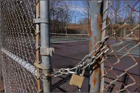  ?? (Arkansas Democrat-Gazette/Colin Murphey) ?? A lock and chain keeps the gate secured Saturday at the tennis courts located near the swimming pool in the Indian Hills neighborho­od of North Little Rock. The Indian Hills Community Club has pushed a proposal to have the neighborho­od pay for the upkeep of the tennis courts and pool.