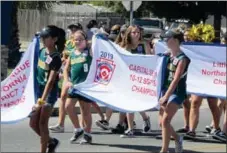  ??  ?? Members of the Olivehurst-linda Little League softball team paraded down Olivehurst Avenue Sunday afternoon as a way to honor the team for its secondplac­e finish at the Western Regional all-star tournament in San Bernardino.