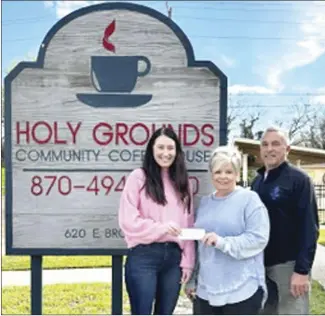  ?? Submitted Photo ?? Amy McKennon, left, representi­ng Holy Grounds Community Coffeehous­e, present the "Change for Change" donation for the months of January and February to Melissa Ward and Joey Astin with St. Francis Area Deveopment­al Center and the Polar Plunge fundraiser. Holy Grounds uses the tips and donations for a two-month period for their mission "Change for Change" that goes to non-profits in the community.