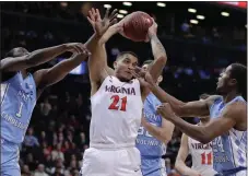  ?? File, Julie Jacobson / AP ?? Virginia forward Isaiah Wilkins (21) pulls down a rebound against UNC.