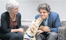  ?? SARAH ESPEDIDO/ORLANDO SENTINEL ?? Brenda S. Kennedy of Canine Companions for Independen­ce and Brian Hare, a professor at Duke University, with canine, Marlene, a hearing assistance dog in training.