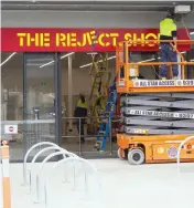  ??  ?? Tradespeop­le work on the Reject Shop store opening in the new retail precinct.