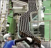  ?? AP/KOJI SASAHARA ?? In May, an Asahi Breweries employee works on the production line at a factory in Moriya near Tokyo.