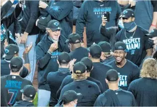  ?? /COREY SIPKIN/AP ?? Miami Marlins manager Don Mattingly celebrates with the team in clinching a playoff berth after their win in the 10th inning of a baseball game Friday at Yankee Stadium.