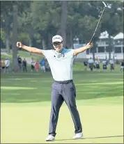 ?? CHARLIE NEIBERGALL — THE ASSOCIATED PRESS ?? Michael Kim, a former Cal star, strikes a triumphant pose after earning his first PGA Tour victory in 85 starts, at the John Deere Classic. He won by a record eight strokes.