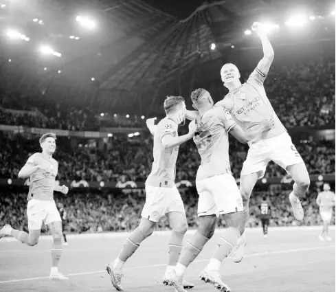  ?? AP ?? Manchester City’s Erling Haaland (right) and his teammates celebrate their third goal during the Champions League semifinal second leg football match against Real Madrid at Etihad stadium in Manchester, England, on Wednesday.