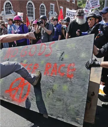  ?? ?? White nationalis­ts, neo-nazis and members of the ‘alt-right’ clash with counter-protesters during the Unite the Right rally in Charlottes­ville, Virginia