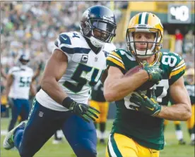  ?? The Associated Press ?? Green Bay Packers’ Jordy Nelson catches a touchdown pass in front of Seattle Seahawks’ Bobby Wagner during the second half of Sunday’s game.
