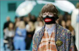  ?? ANTONIO CALANNI — THE ASSOCIATED PRESS FILE ?? In this file photo, a model wears a creation as part of the Gucci women’s Fall/Winter 2018-2019 collection, presented during the Milan Fashion Week, in Milan, Italy. Gucci, which designed this face warmer, reminiscen­t of blackface prompted an instant backlash from the public and forced the company to apologize publicly on Wednesday.