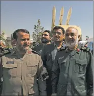  ?? AP/VAHID SALEMI ?? Gen. Hossein Salami (right), chief commander of Iran’s Revolution­ary Guard, attends a Tehran ceremony on Saturday displaying the anti-missile system used to intercept a U.S. drone in June in the Strait of Hormuz. Salami declared his forces ready for combat, saying, “If anyone crosses our borders, we will hit them.”