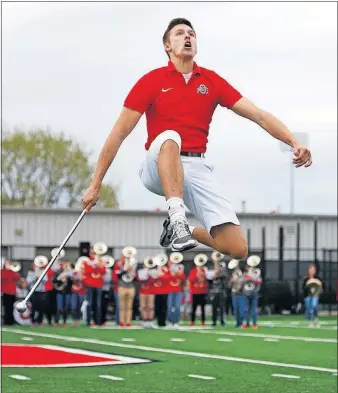  ?? PHOTOS] [FRED SQUILLANTE/DISPATCH ?? John LaVange shows his spirit during his tryout for head drum major.