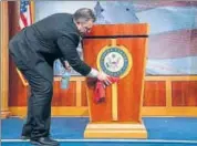  ??  ?? An official disinfects a podium before a press briefing with US Senate majority leader Mitch Mcconnell.
AP