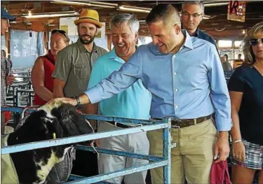  ?? MID-HUDSON NEWS NETWORK ?? Dutchess County Executive Marc Molinaro pets a goat at the Dutchess County Fairground­s in Rhinebeck on Thursday.