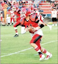  ?? MARK HUMPREY ENTERPRISE-LEADER ?? Farmington senior quarterbac­k Trey Waggle picks up good yardage on this carry. He ran 7 times for 9 yards and passed for 218 yards and 2 touchdowns on 9 of 13 passing. Waggle guided the Cardinals to touchdowns on their first five possession­s in...