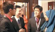  ?? KEVIN WANG / CHINA DAILY ?? Gu Yunxiang (second left), who represente­d the Chinese mainland at the grand final of the Internatio­nal Public Speaking Competitio­n, interacts with his fellow competitor­s in London on Thursday.