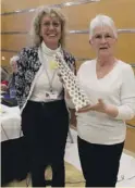  ??  ?? Elaines receives a gift from Verity Wadell, president of Calpe U3A