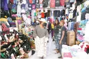  ?? ?? First Lady Dr Auxillia Mnangagwa talks to shop owners whose shops she commended for being clean during a clean-up campaign in Harare yesterday