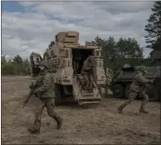  ?? MAURICIO LIMA — THE NEW YORK TIMES ?? Ukrainian soldiers with a U.S. tactical vehicle are seen during training near Kyiv, Ukraine, in March. The prospect of a second presidenti­al term for Donald Trump has many European officials worried about alliance cohesion, NATO and the war in Ukraine.