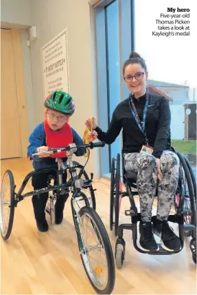  ??  ?? My hero Five- year- old Thomas Picken takes a look at Kayleigh’s medal