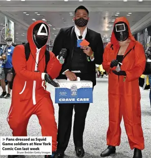  ?? Bryan Bedder/Getty Images ?? > Fans dressed as Squid Game soldiers at New York Comic Con last week