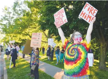  ?? JACK HANRAHAN/AP ?? Kassondra McHenry, of Erie, and fellow members of Erie Equal demonstrat­e June 16 at Frontier Park. The group was protesting Erie Mayor Joe Schember’s decision to not fire an Erie police officer caught on video kicking a seated protester during a May 30 downtown riot.