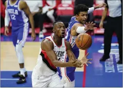  ?? THE ASSOCIATED PRESS ?? Portland Trail Blazers’ Harry Giles III, left, and the Sixers’ defending guard Matisse Thybulle chase after a loose ball during a game between the teams last Thursday at Wells Fargo Center.