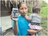 ??  ?? Claudia Maquin, 27, shows a photo of her daughter, Jakelin, who died in a U.S. hospital.