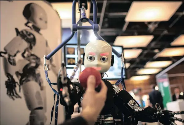  ?? PICTURE: LAURENT CIPRIANI/AP ?? INNOVATION: The iCub robot tries to catch a ball during the Innorobo European summit, an event dedicated to the service robotics industry, in Lyon, France, in 2013. The iCub robot, created by the Italian Institute of Technology, is used for research into human cognition and artificial intelligen­ce.