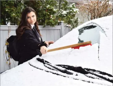  ?? STEVE MacNAULL/The Okanagan Weekend ?? Reporter Steve MacNaull’s new-driver daughter, Grace, wasn’t impressed with Friday morning’s first snowfall of the season.