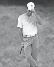  ??  ?? Tiger Woods reacts prior to attempting a birdie putt during Thursday’s first round of The National golf tournament at TPC Potomac at Avenel Farm. GEOFF BURKE/USA TODAY SPORTS