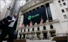  ?? RICHARD DREW — THE ASSOCIATED PRESS ?? A Spotify banner adorns the facade of the New York Stock Exchange, Tuesday. Spotify, the No. 1 music streaming service which has drawn comparison­s to Netflix, is about to find out how it plays on the stock market in an unusual IPO.