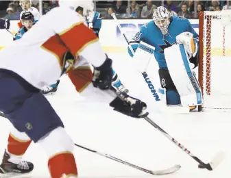  ?? Ezra Shaw / Getty Images ?? Sharks goalie Martin Jones keeps his eyes on the puck against the Florida Panthers at SAP Center. The Sharks lost for only the second time in eight outings.